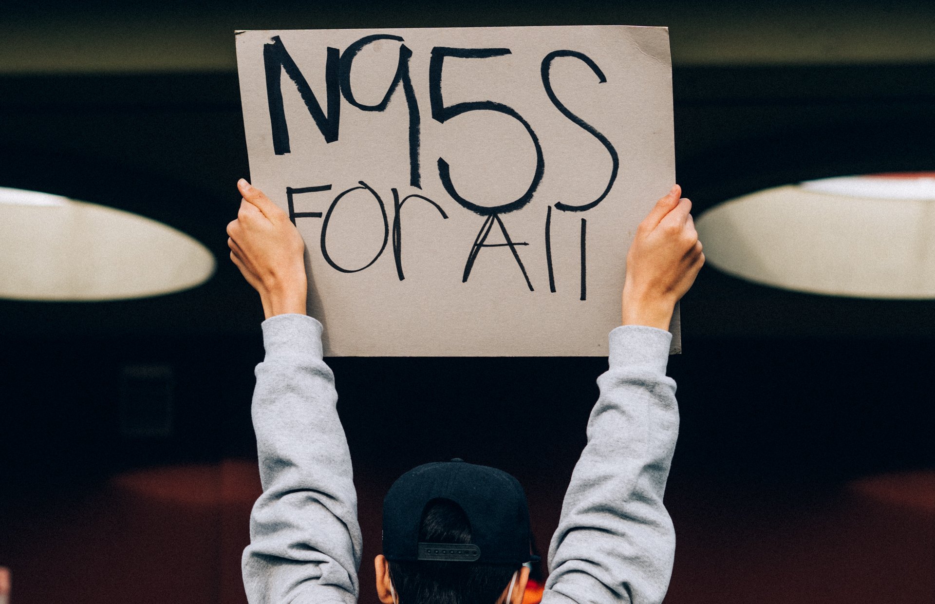  A teen from Seattle Public Schools holds a protest sign reading “N95s for all” during a student-led walkout that met at district headquarters to demand better Covid safety measures in public schools. January 15, 2022 in Seattle, Wash.  