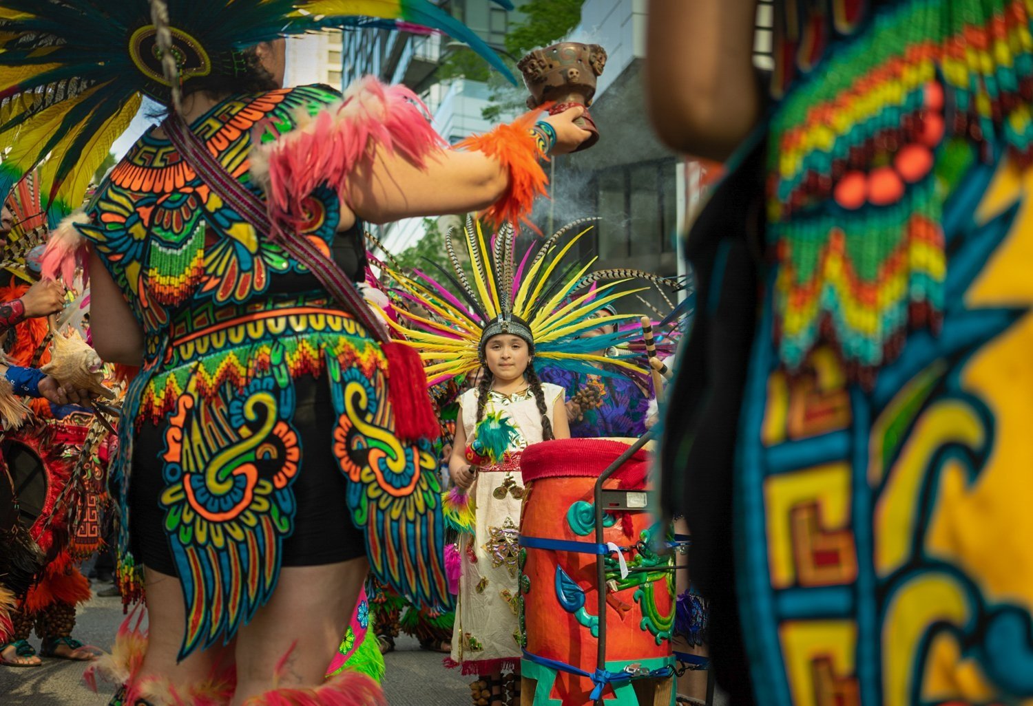  The youngest member of CeAtl Tonalli, an Aztec dance group, leads the 2018 May Day labor march in Seattle, Wash. 