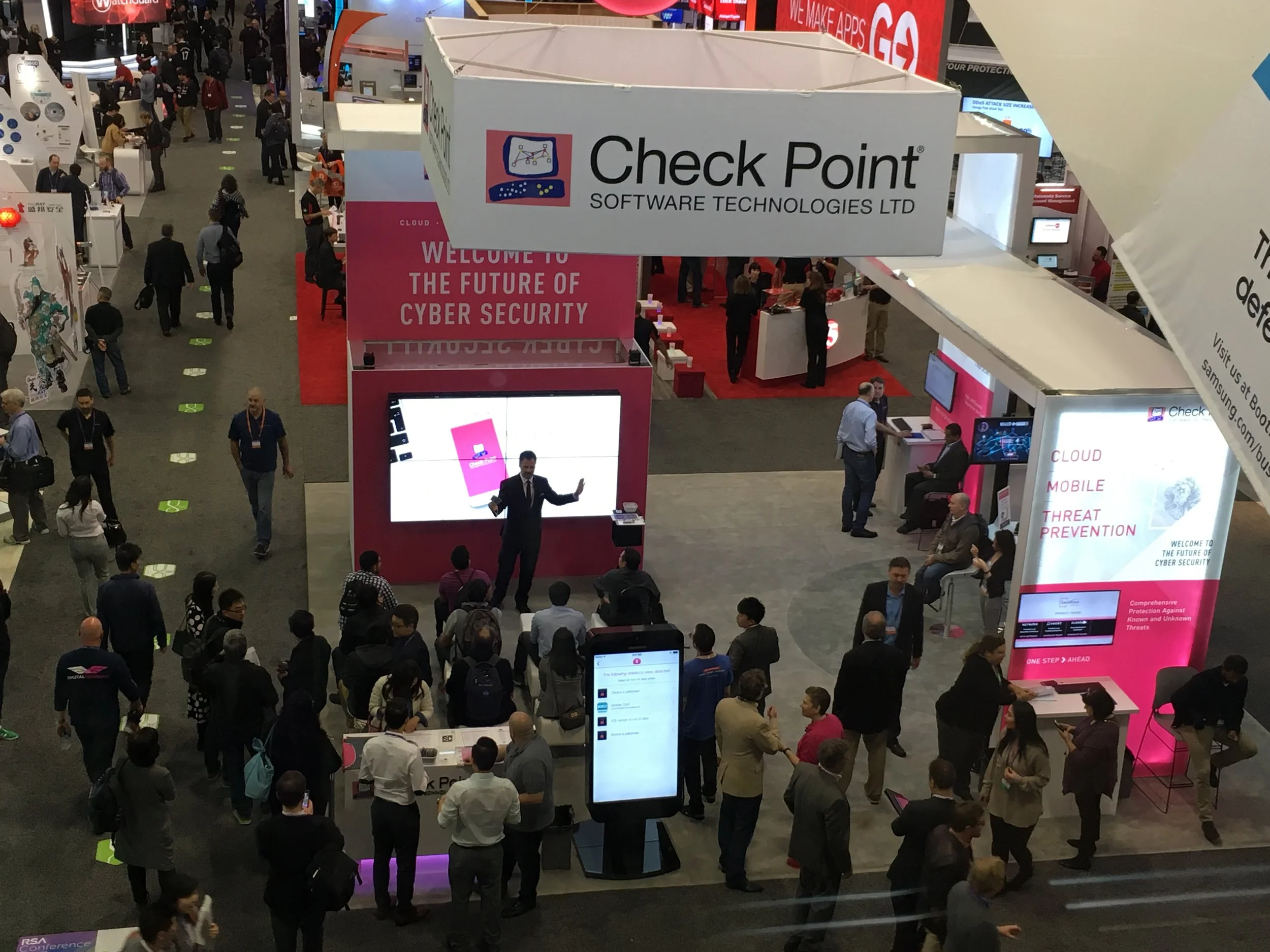 Birds-eye view of Dennis Kyriakos pulling large crowds into Check Point's exhibit booth. 