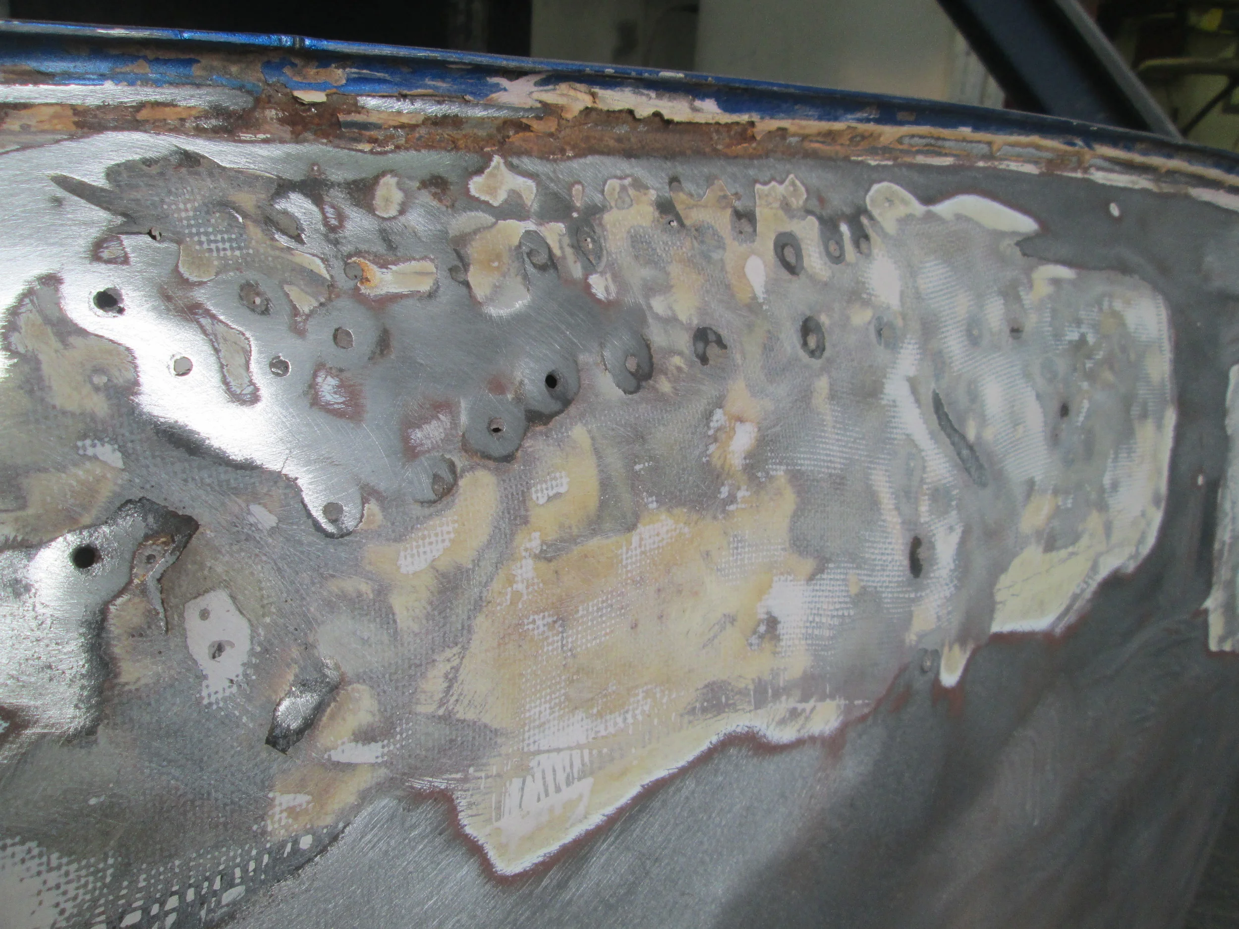  There were a few holes where there was an attempt to pull out the extensive dents in the roof. 