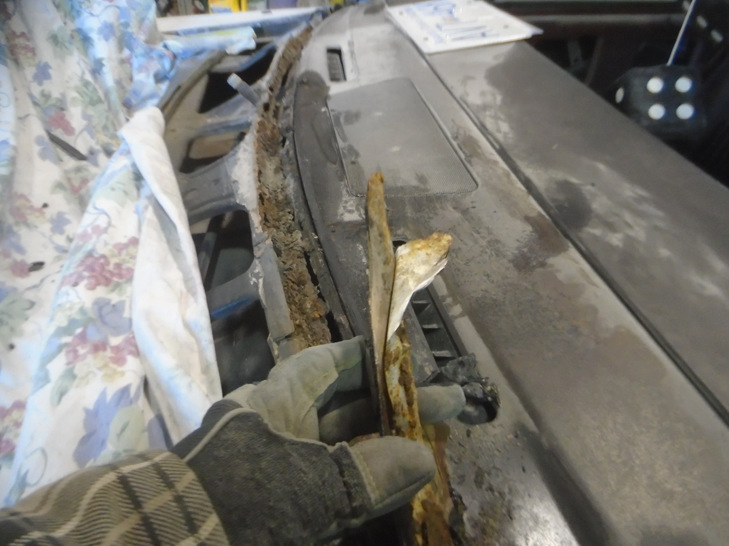  Gobs and gobs of bondo, tin tape and who knows what else was in there to fill the rusted out holes across the entire cowl 