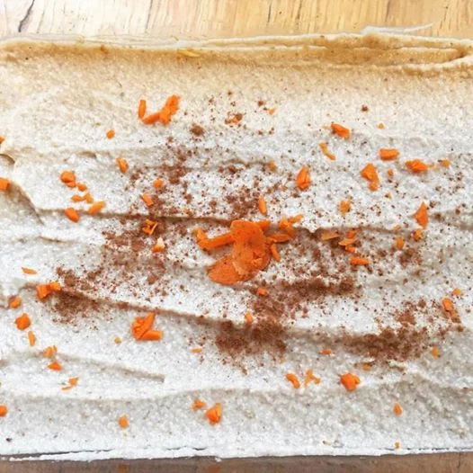FOR THE CAKE 1. 2 carrots grated 2. 1 cup unsweetened shredded coconut 3. 1 cup walnuts crushed 4. 1 cup soaked and pitted dates 5. 1/4 cup coconut oil 6. 2 tsp. cinnamon INSTRUCTIONS In a large mixing bowl add the carrots, coconut, walnuts, cinnamon, mix well. Blend the drained dates and coconut oil until smooth. Add this to the mixing bowl. Mix really well until combined (it's easiest to use your hands). Put the mixture in a loaf pan (I like to use glass) Place into the fridge for around 10-15 minutes. FOR THE FROSTING 1. 1/2 cup raw and soaked cashews 2. 1/2 cup unsweetened shredded coconut 3. 1/4 cup coconut oil 4. 1 lemon juiced 5. ½ cup soaked dates (save the water) INSTRUCTIONS 1. Blend cashews, coconut, coconut oil, lemon juice and dates. It will take around 5 minutes. Add in the soaked date water a little at a time until desired consistency 2. Take the cake out of the refrigerator and smooth on the frosting. Sprinkle with cinnamon or other garnish on top