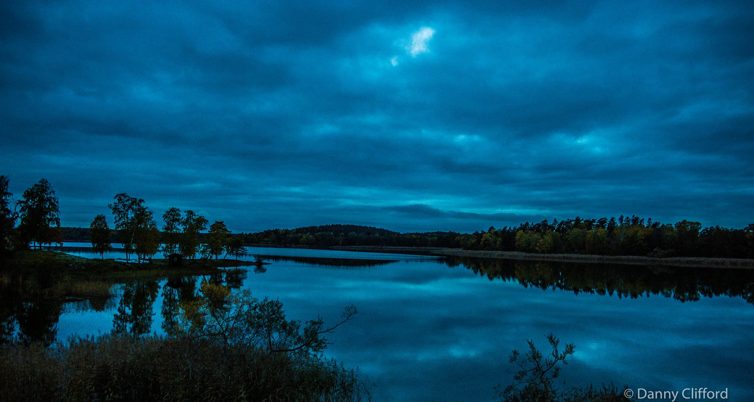 Sundown and almost dark as we look across the lake behind Tony &amp; Christine’s house in Stockholm.