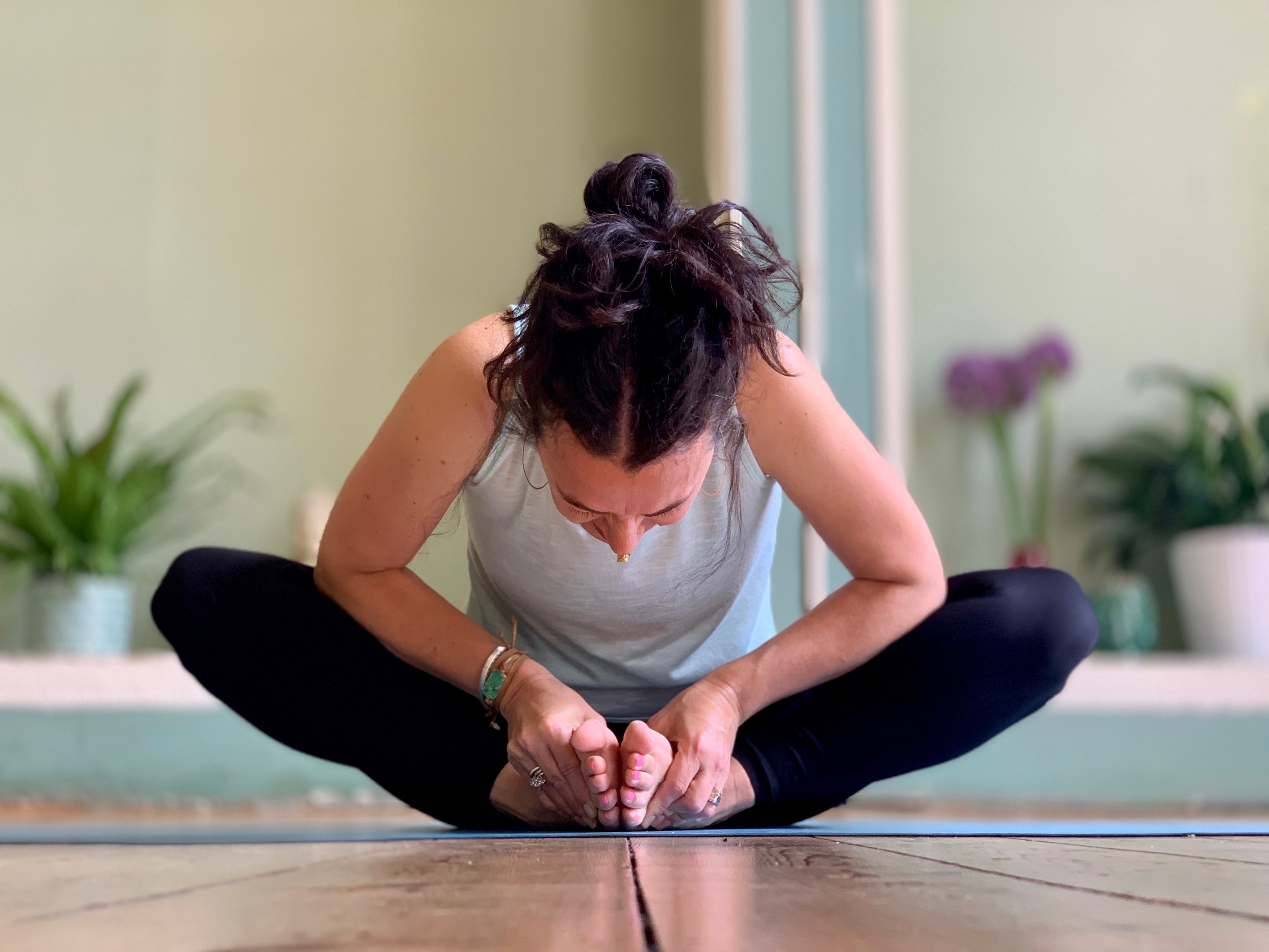 Woman with yoga instructor in class, asana cobbler pose Stock Photo | Adobe  Stock
