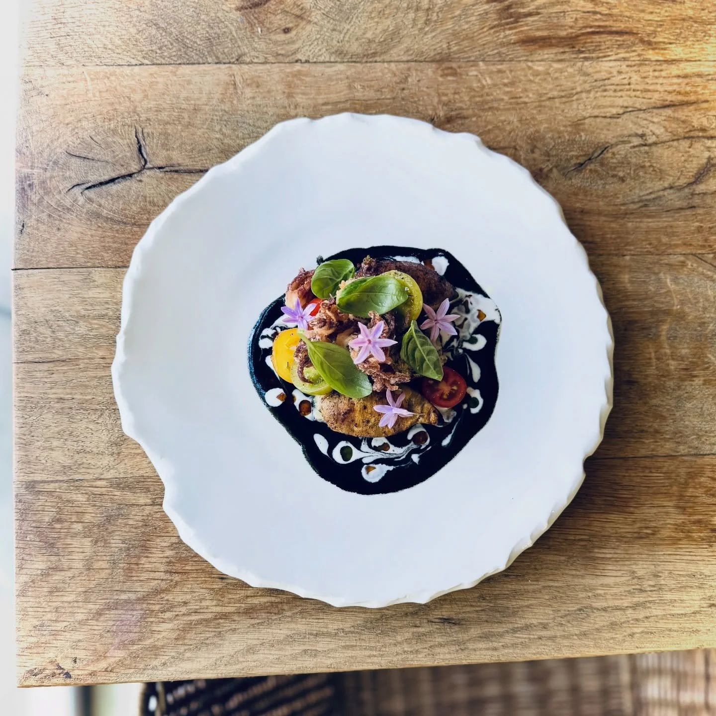 Come for lunch and taste the dishes everyone will be talking about this week.

📸:
1. Stuffed &amp; quick grilled Squid, crispy Tentacles, Squid Ink Beurre Blanc, smoked Cream, marinated Tomatoes, Basil
2. Braised Lamb Neck, crispy Phyllo Pastry, Pom