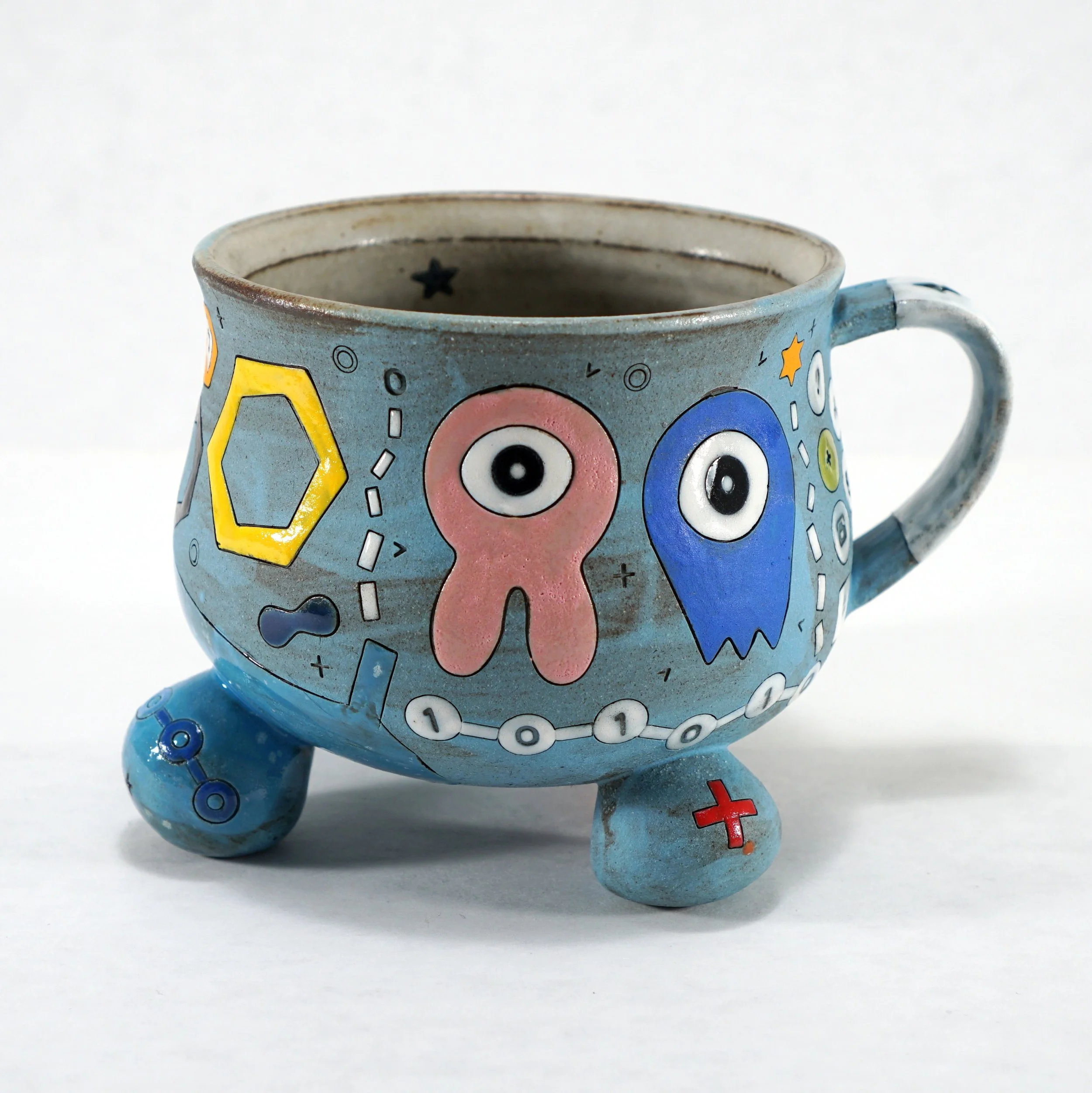 Blue Tripod Alien Mug 👾👽

Fresh out of my kiln! This is my newest mug form, and I&rsquo;m really excited about how it turned out.

Having the cup body sit on three legs gives the mug such an organic feel. Plus, that little space underneath is the p
