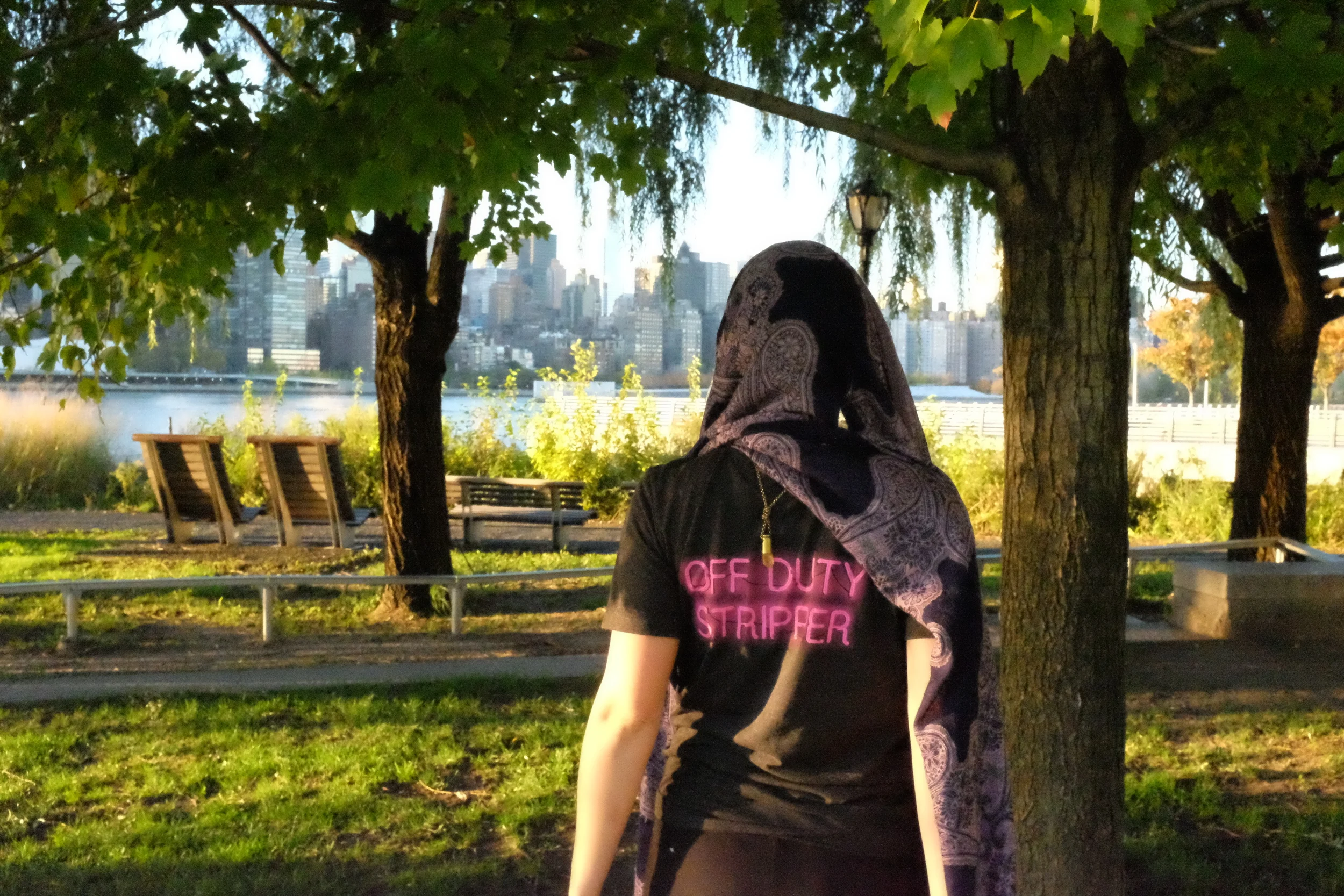 Amber wears the OFF DUTY STRIPPER T in a size small in grey, worn backwards. 
