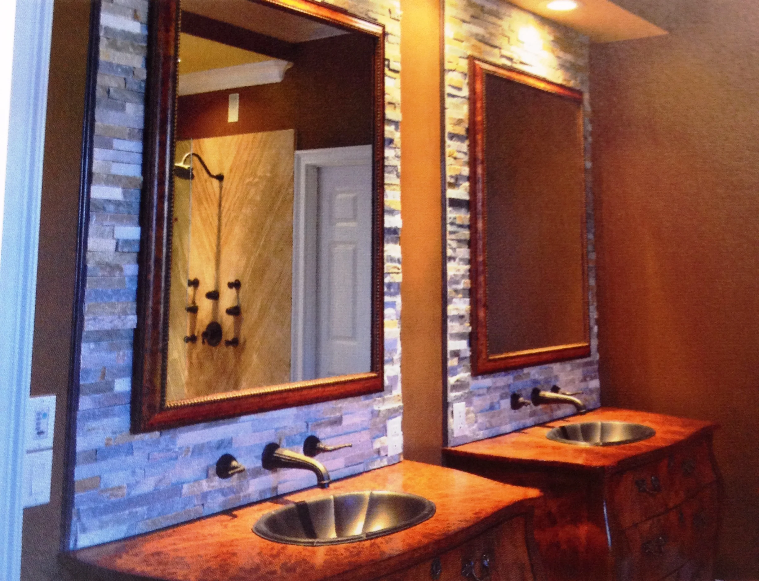 Tah dah! Custom-fitted bombe chests, Venetian sinks and a stacked marble backsplash create a dramatic his and hers vanity area in the reno.
