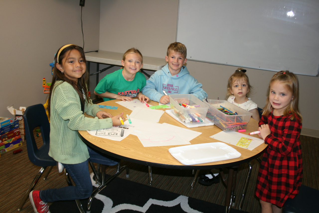 Kids min 2025 around a table.png