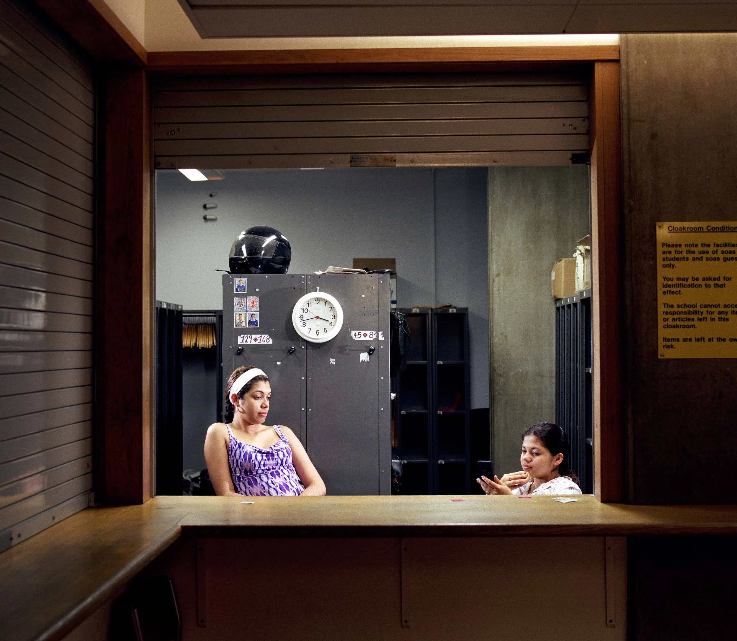 cloakroom attendant women bored and waiting for customers