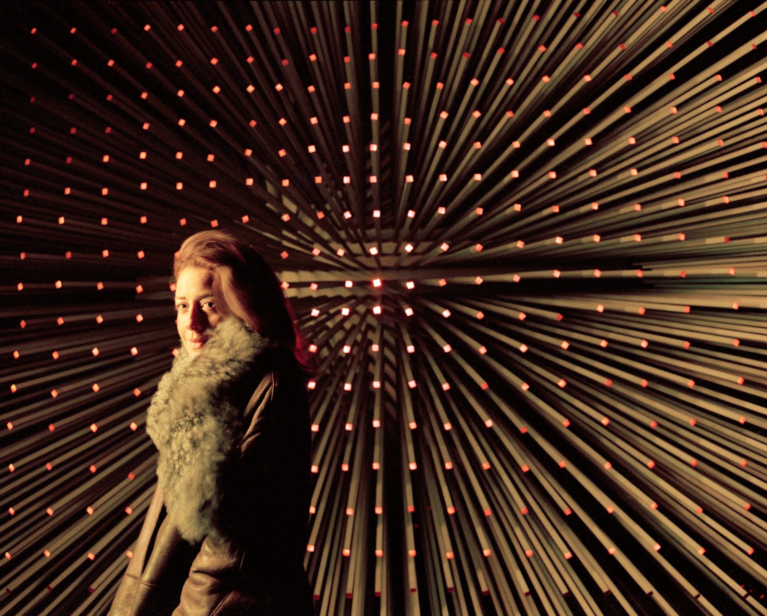 lucy jago writer in front of thomas heatherwick cube sculpture at night essex england
