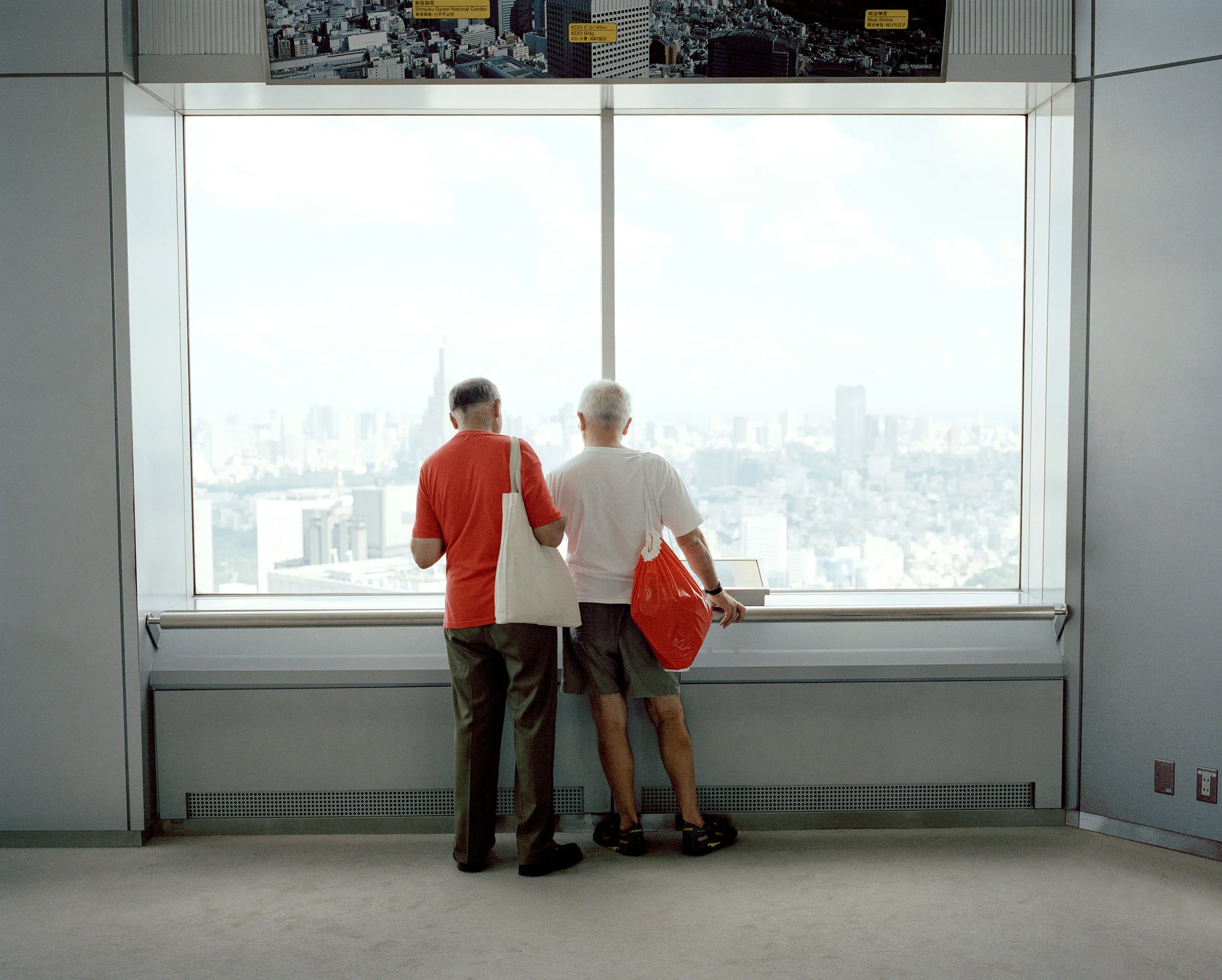 two men looking at high view from Metropolitan Government Building Shinjuku Tokyo