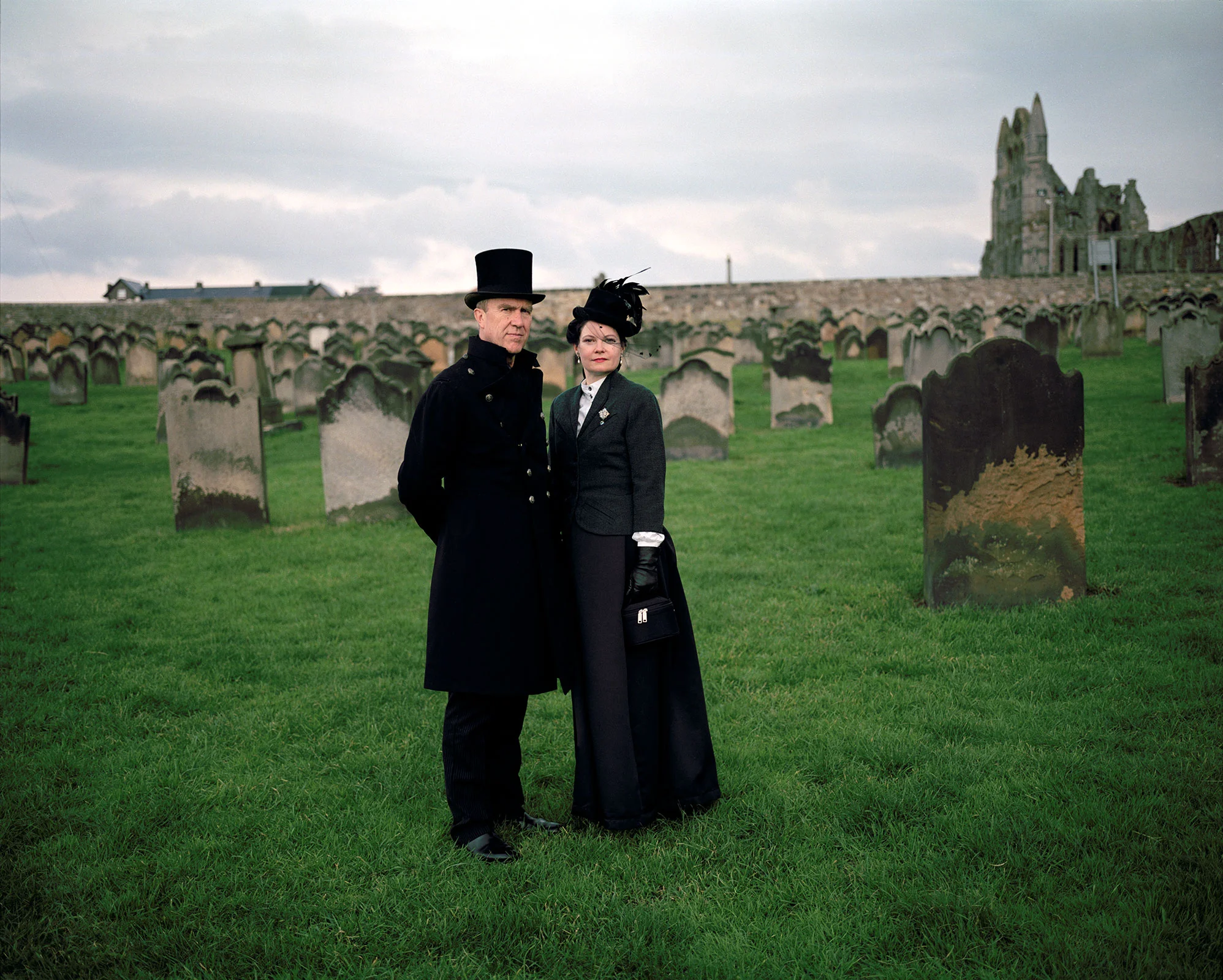 gothic couple in gothic costume top hat Whitby Abbey Whitby Goth weekend