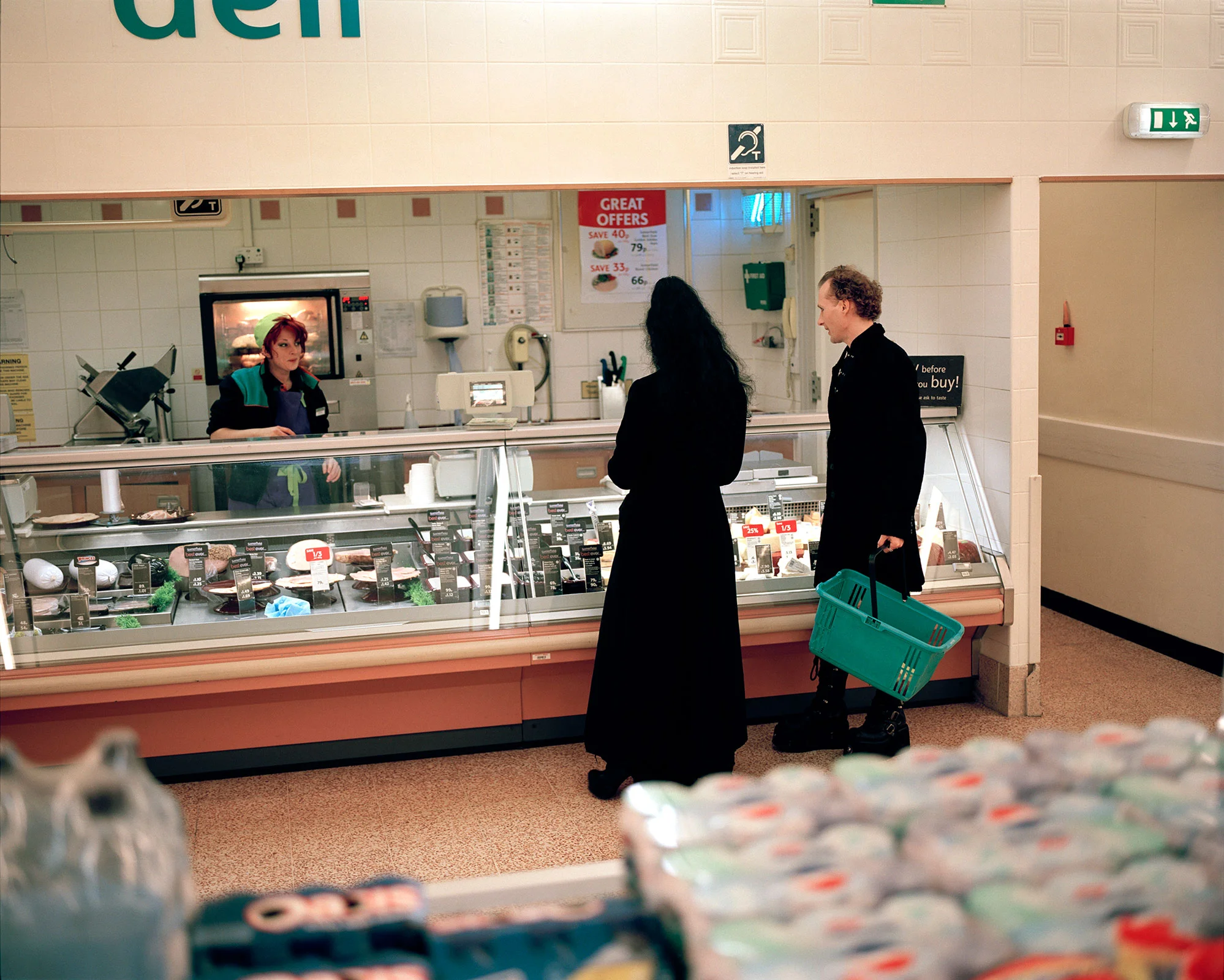 goth couple shopping at supermarket deli counter during Whitby Goth weekend