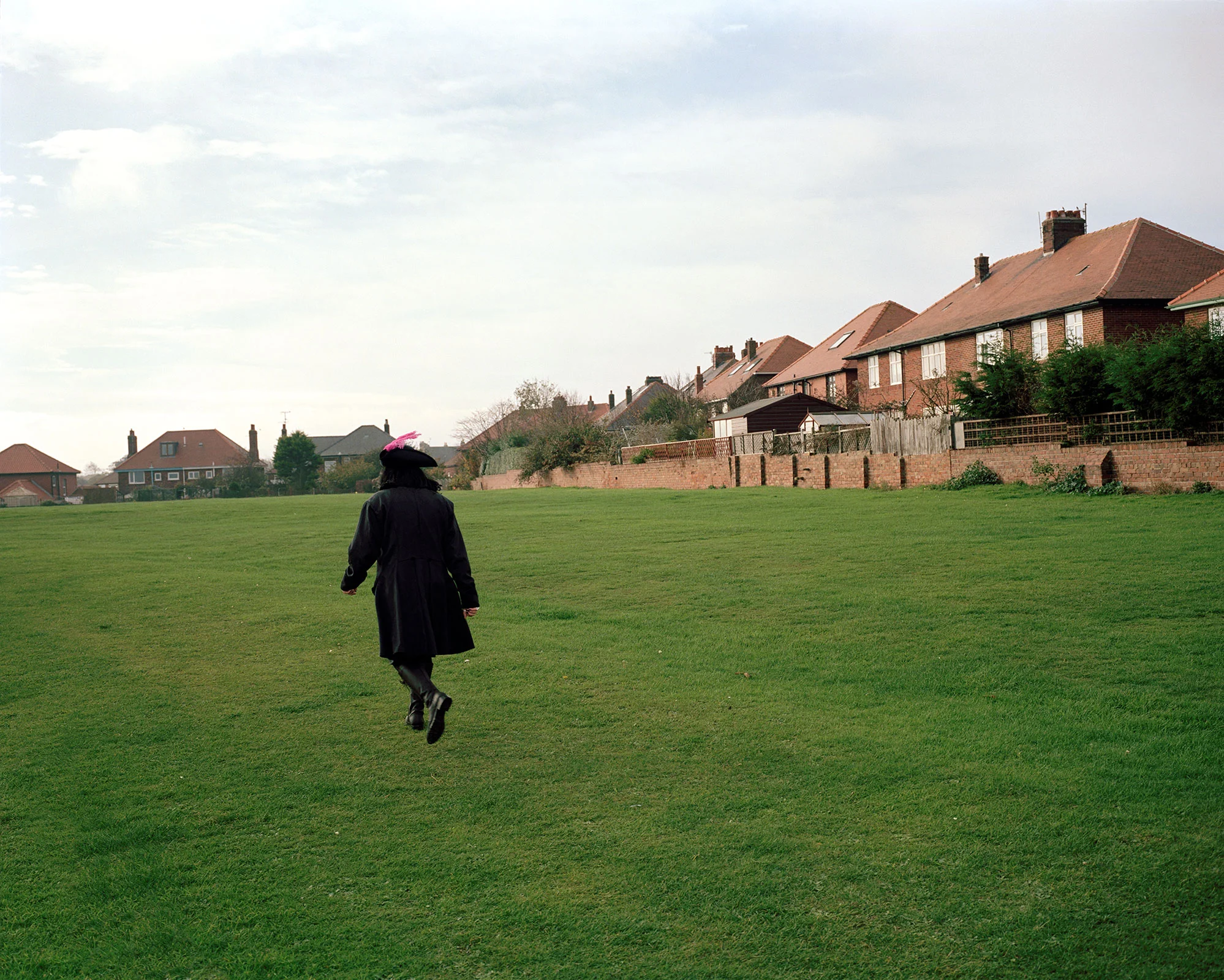 goth man gothic costume in housing estate at Whitby Goth weekend