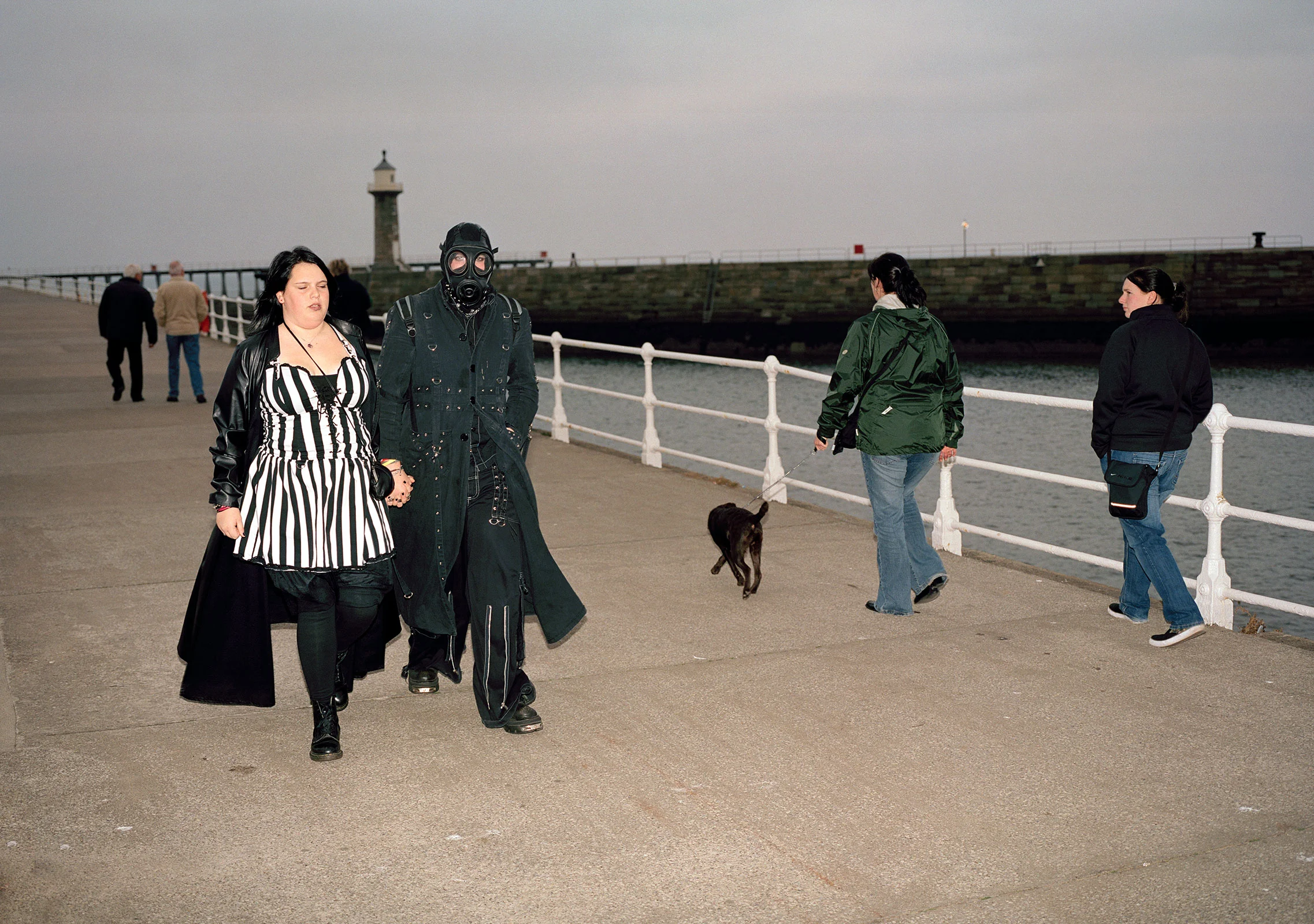 goth couple with gothic clothes and gas mask during Whitby Goth weekend