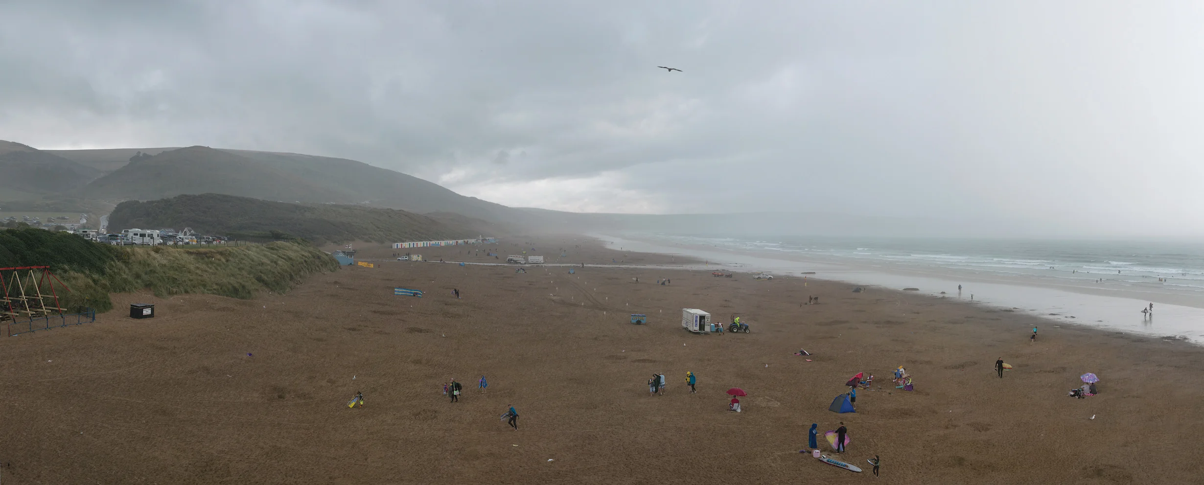 people at the beach in rain Woolacombe