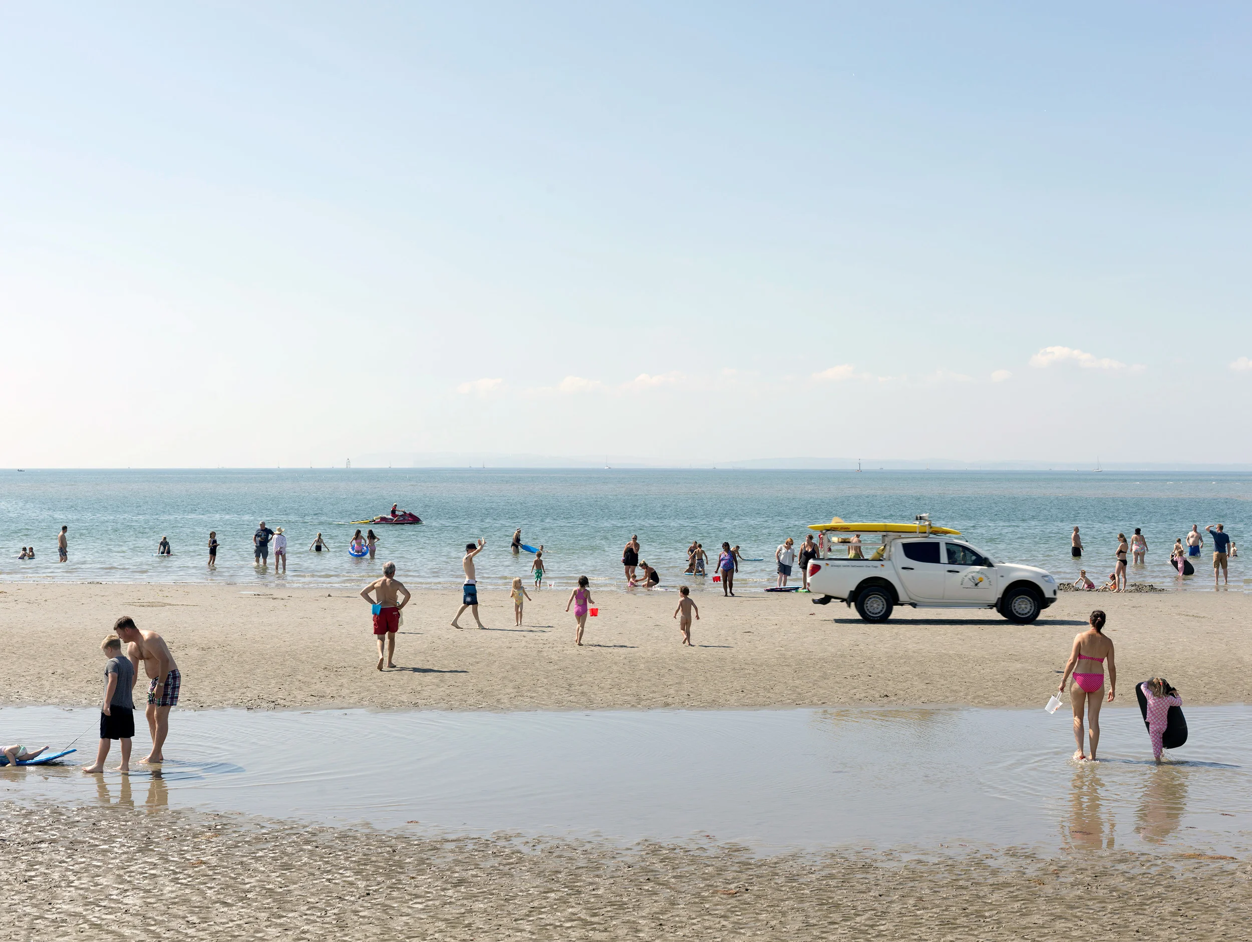 people at crowded beach with lifeguards West Wittering