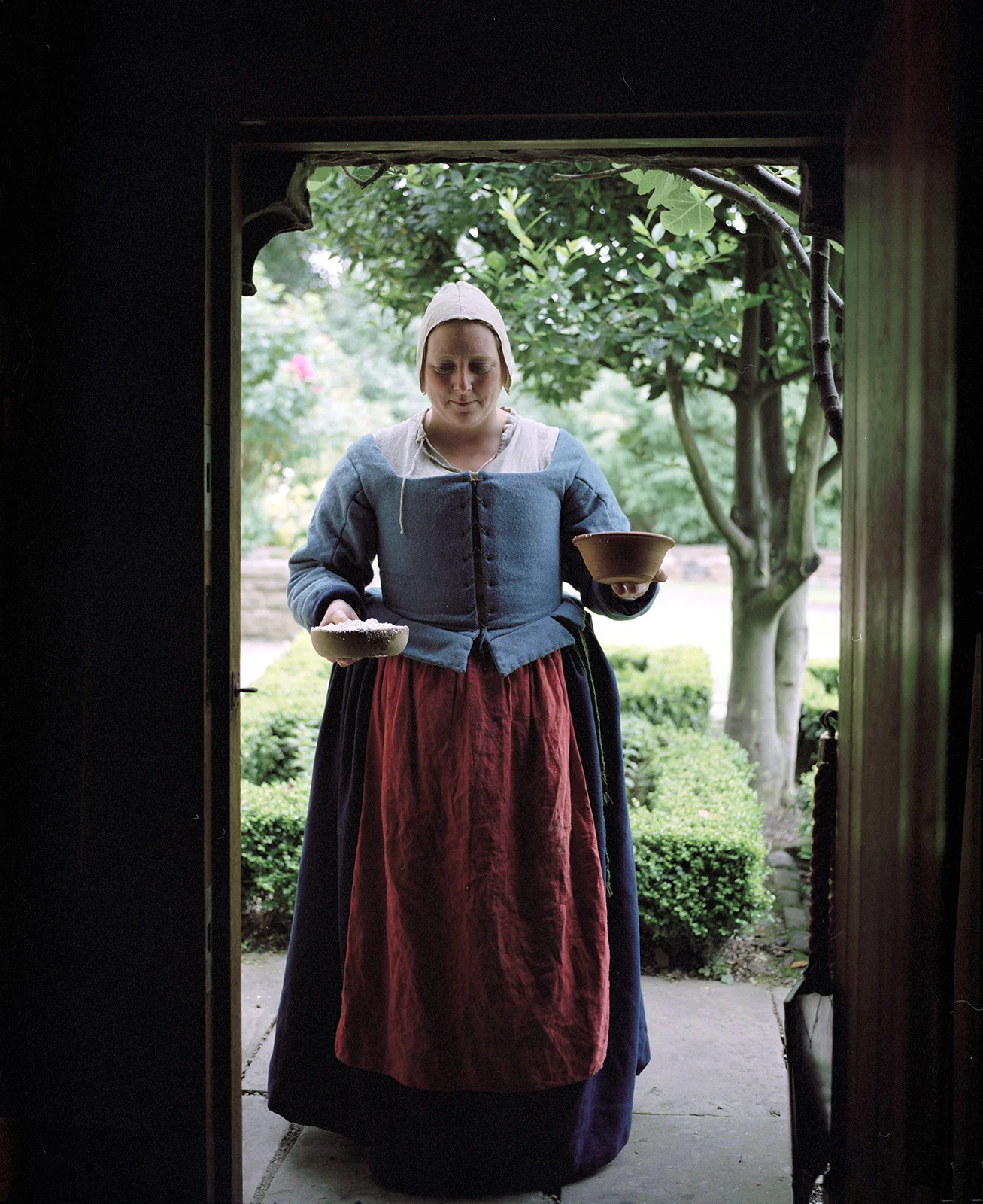 reenactor lady cook with dishes 1643 english civil war yorkshire england