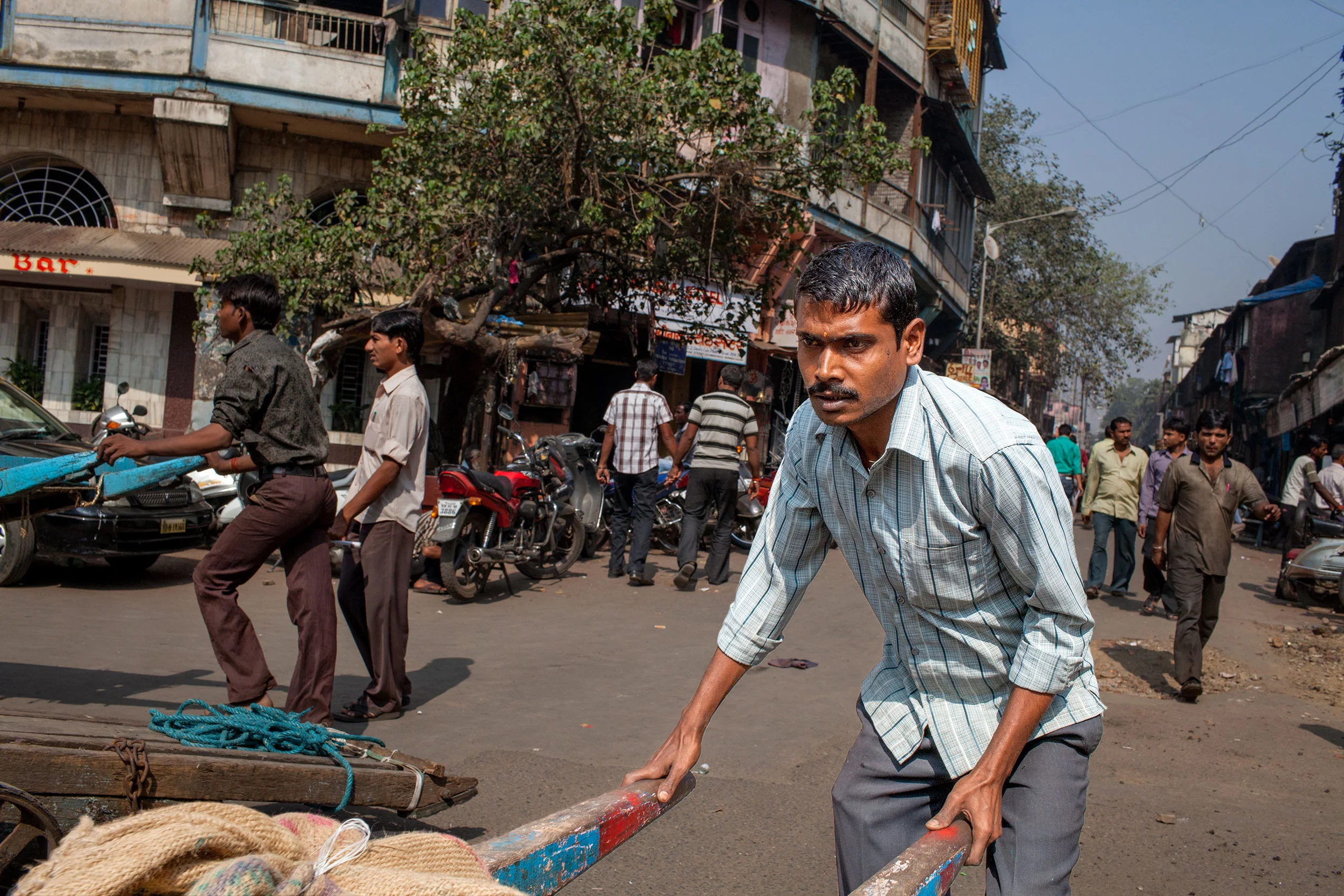 Dunk-McKenzie-PublicDomain-porter-cart-puller-man-pulling-cart-bendhi-bazaar-mumbai-india.jpg