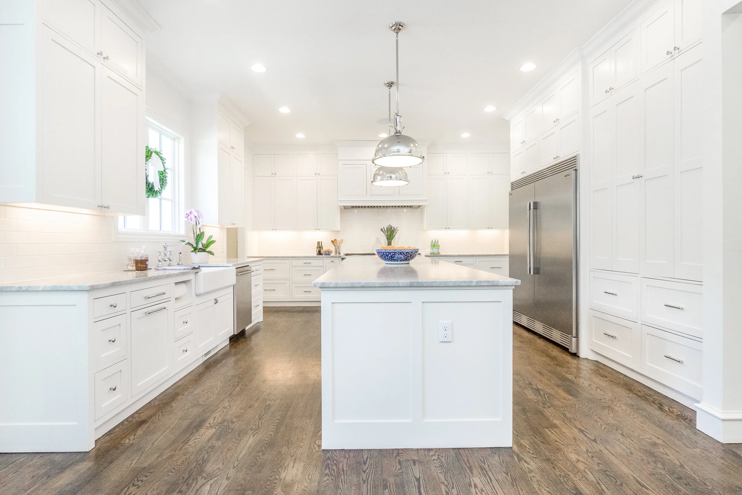 What a wonderful working kitchen! A place for everything! The tall cabinets on the right open for a work center. Small appliances and measuring items—all at your fingertips.