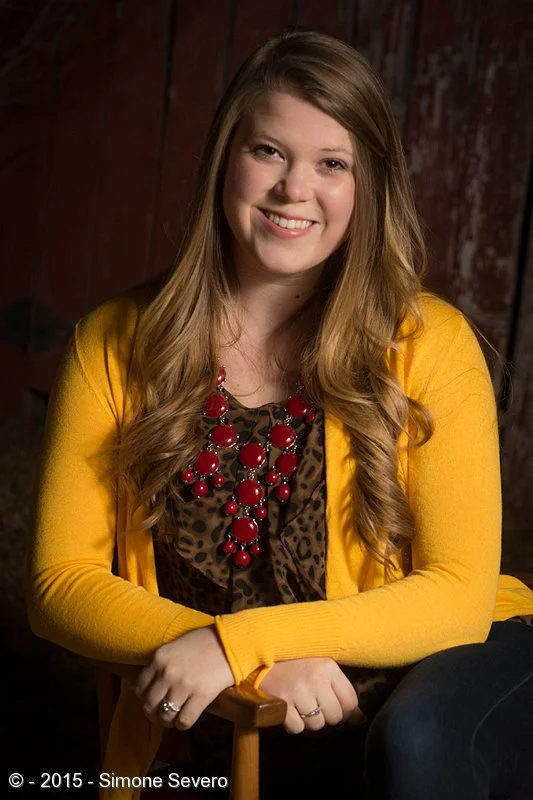 She is the light of the party, always smiling. When I invited her for the portrait a day project she told me she would wear a blue shirt. To my surprise, she came in this beautiful yellow sweater, which was perfect for the&nbsp;red fence background …