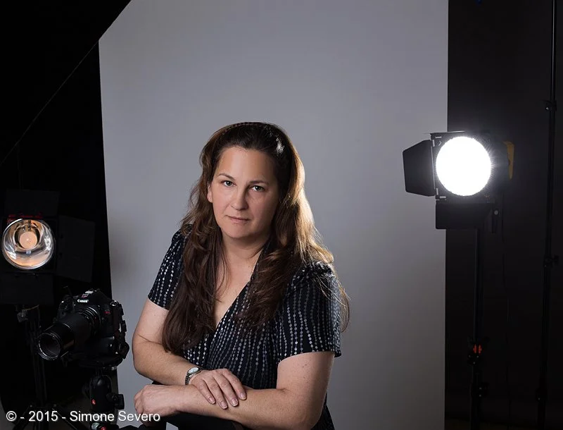 Dora and I are always chasing the light. When she accepted my invitation to be the portrait of the day I had this idea of doing the image outdoors, but the snow did not allow me. A portrait of a great photographer needed to show off the kind of tool…