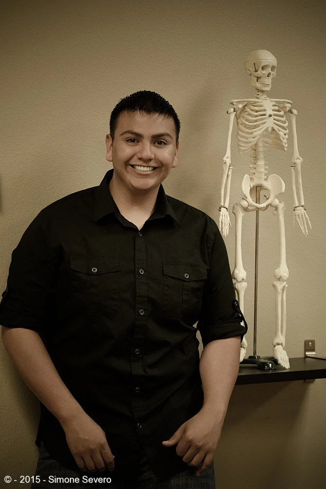 Sylvester is a massage therapist and he has this big young smile in his face all the time. I saw the skeleton in his office and I thought it would be really cool to have an image of him looking serious &nbsp;by the bones, but instead he thought it w…