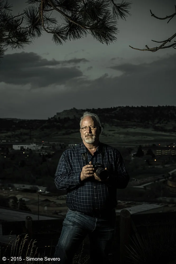 John is in my photography group. I see him often in the classes and field trips so of course he was not surprised when I mentioned A Portrait a Day. I was not sure which idea I was going to develop in his portrait. I learned he is a very good cook: …