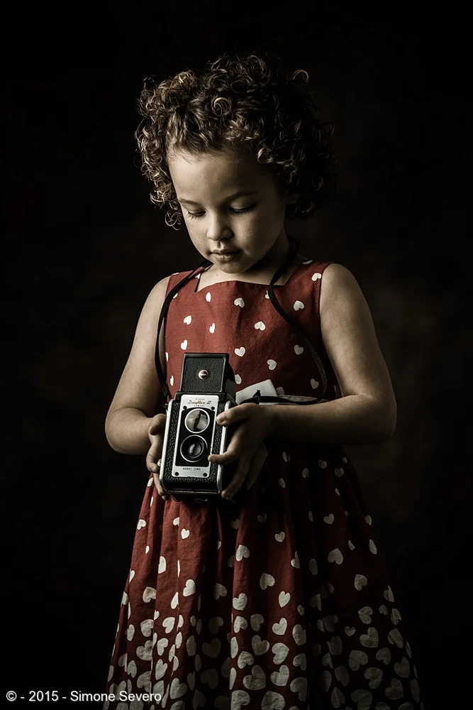 Zya is the first child in A Portrait a Day project. I see her often, visiting her mother, and I cam captivated by her giggles, curiosity and energetic personality. She reminds me of the original movie "Annie" with her curly hair and pretty face. Her…