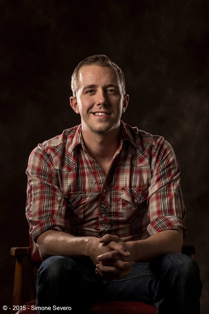 Nathan came over on mother's day. He is Haley's boyfriend - I photographed Haley as a 1920'2 flapper on April 3, portrait # 93. I liked his shirt and I thought it would&nbsp;match the red leather chair. Nathan works as a bartender in two different p…