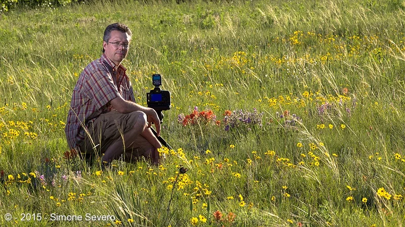 Chris is in my photography group. We were in a flower field trip when I informed him he was going to be my portrait of the day.&nbsp;We, photographers, are used to being behind the camera, so I set my composition to get him in his natural habitat, i…