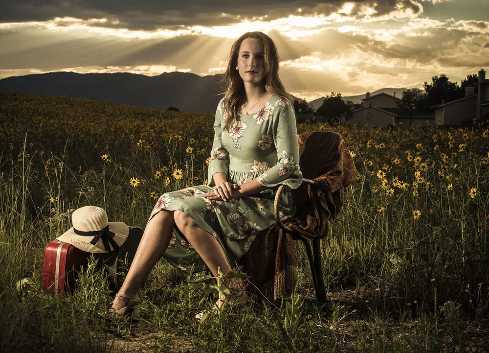 a-colorado-springs-girl-is-ready-for-her-senior-pictures-in-the-sunset-time-in-summer-field-with-sunflowers-7827.webp
