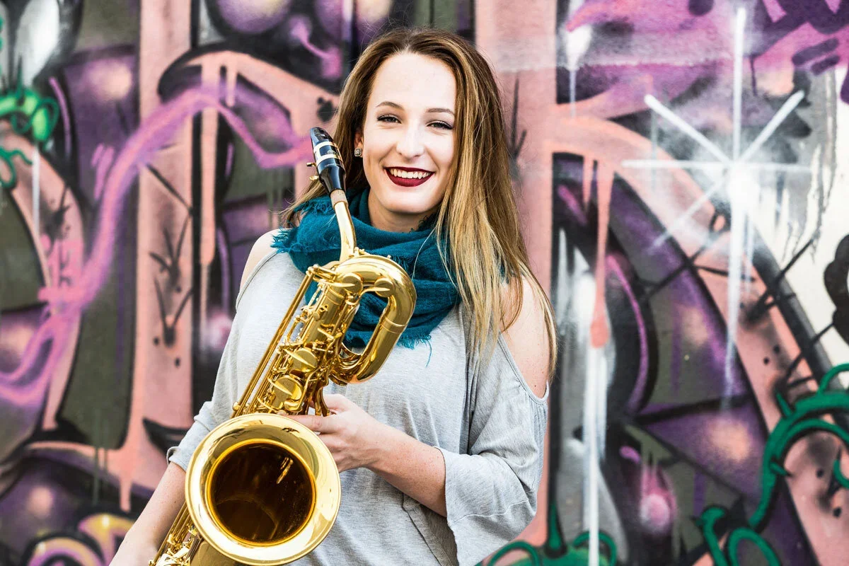girl-with-saxophone-in-graffiti-wall-senior-pictures-outdoors-8268.webp