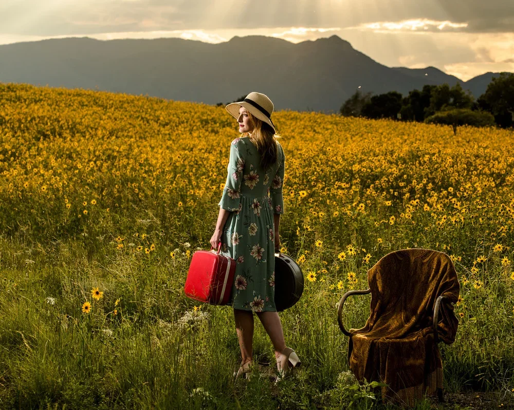 summer-photo-of-young-girl-getting-ready-to-go-away-in-sunflower-field-senior-pictures.webp