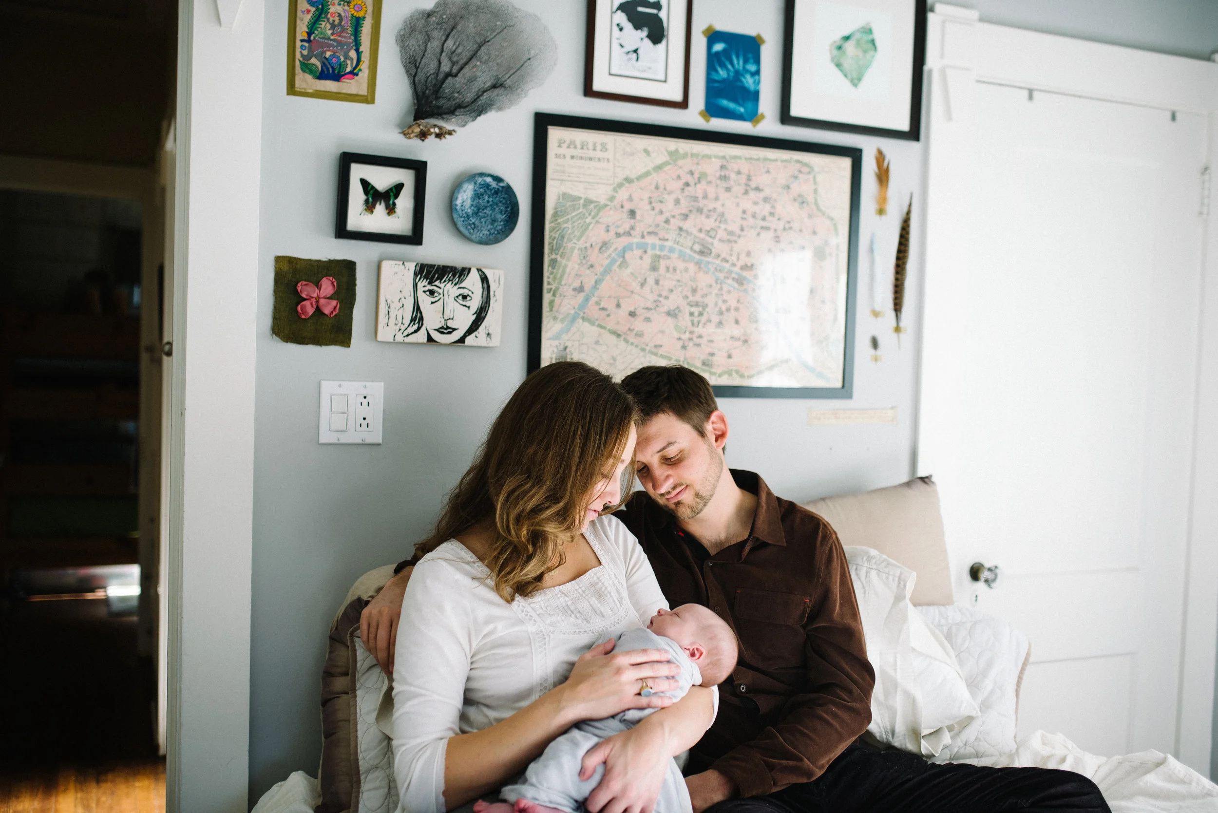 In the image above you can see how everyone is dressed very simply. Mom's shirt has subtle lacy details that add beautiful texture and baby boy is just swaddled in a light grey blanket. The neutral colors chosen beautifully compliment their decor. 