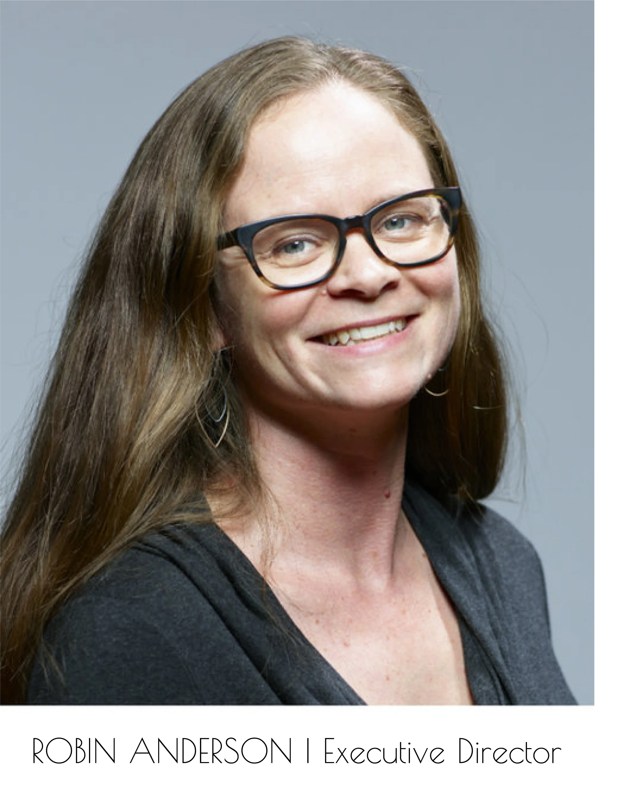Robin Anderson, Engagement Director, smiles at the camera. Her head and shoulders are visible.