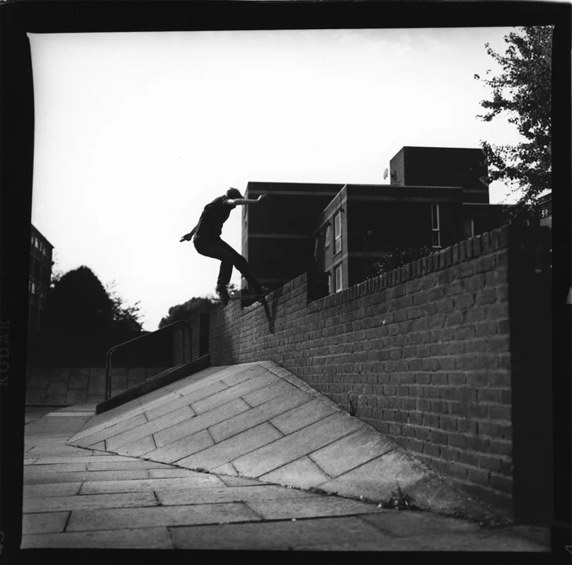 Nick Jensen ollies out of the hip to front nose on this old brick wall in London. Photo by Josh Stewart 2005