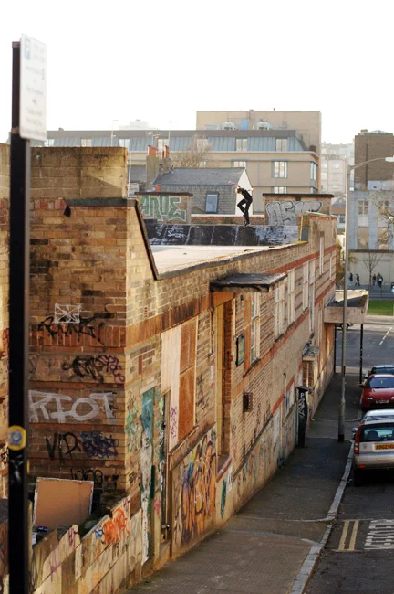 Nick Jensen backside noseblunts the pitch of a roof somewhere in London. Photo by Dominic Marley