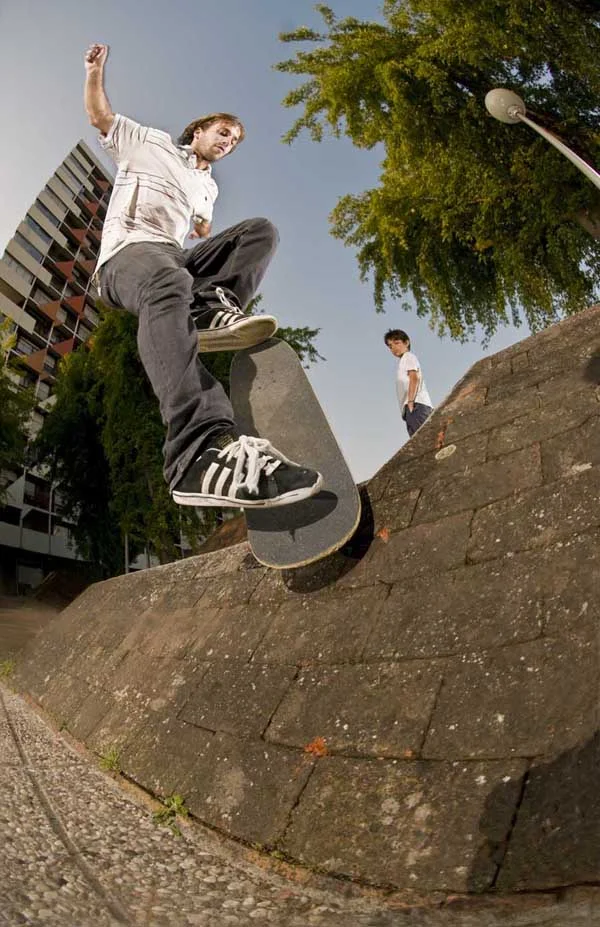 Vivien Feil frontside noseblunts and hops into a brick bank in Gay Paris. Photo by Jean Feil