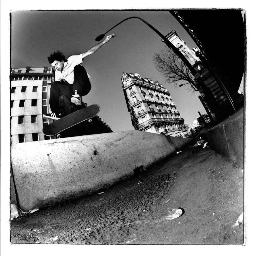Vivien Feil bs flips off a curb and over a barricade in gay-ass Paris. Photo by Jean Feil