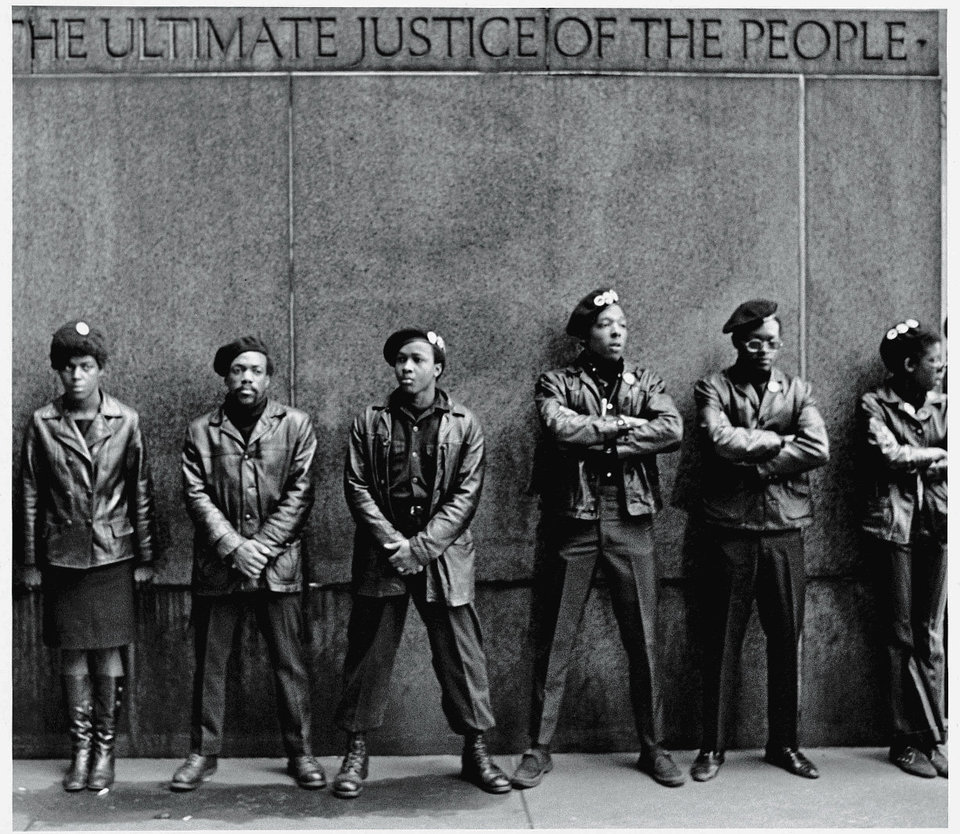 View of a line of Black Panther Party members as they stand outside the New York City courthouse under a portion of an Abraham Lincoln quote which reads 'The Ultimate Justice of the People,' New York, New York, April 11, 1969. (Photo by David Fenton/Getty Images)