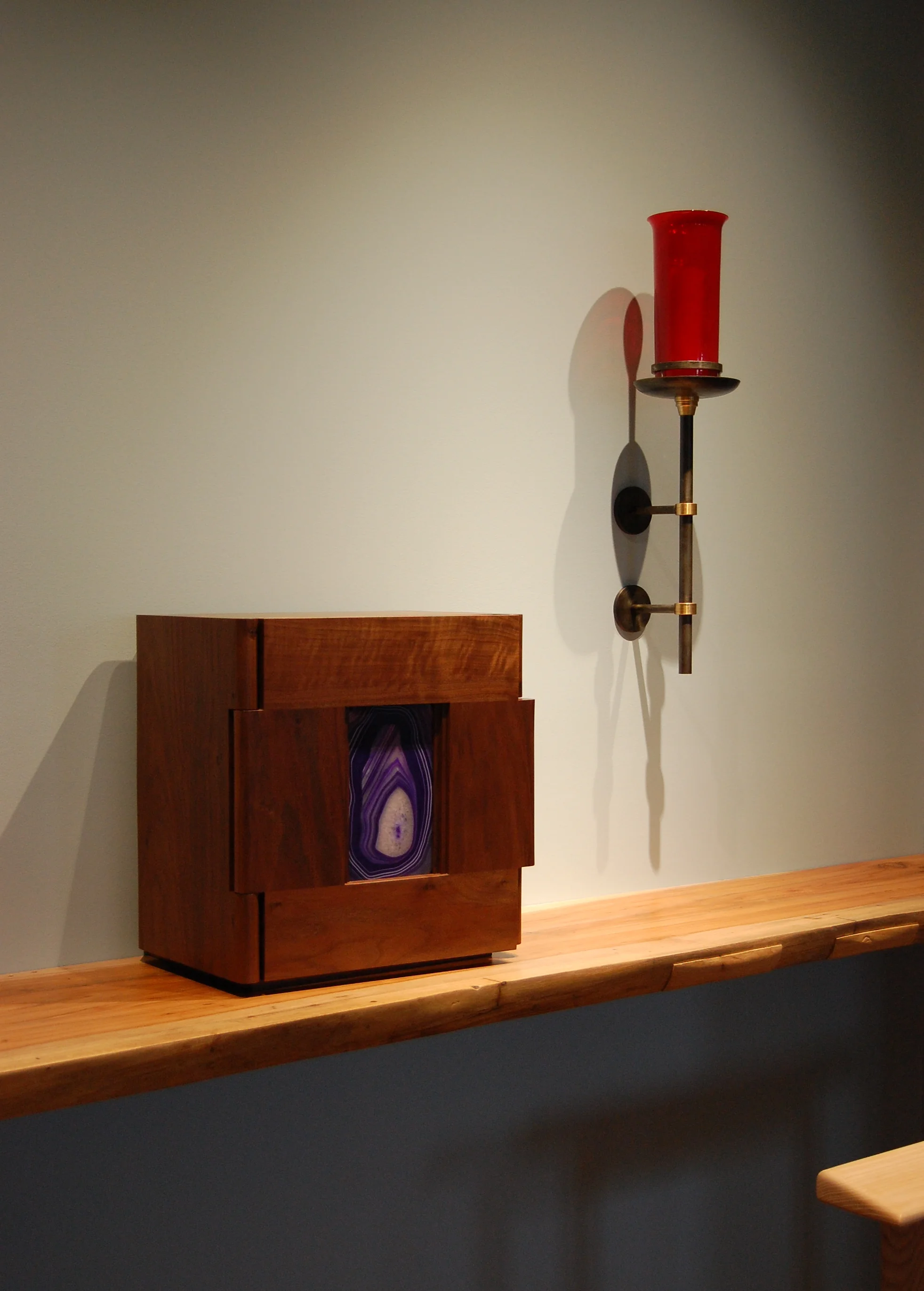  The tabernacle  The ritual act of opening the tabernacle door is expressed by the unique wood knuckle hinges.  The door has no handle, per se.  When the key is turned, recessed magnets push the door open . 