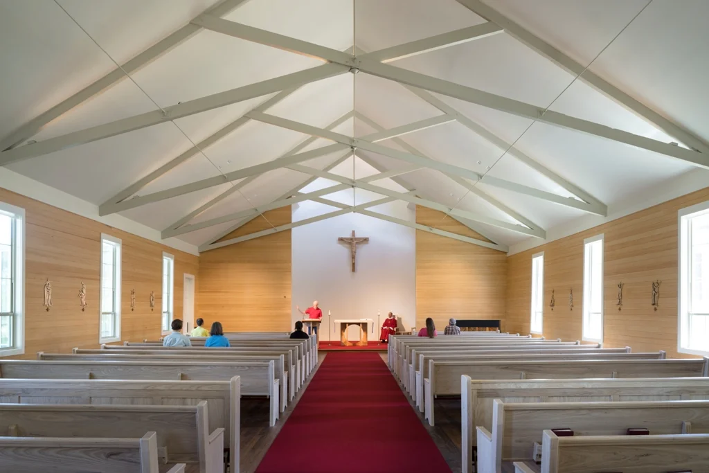  St. Edward's Chapel renovation by Pollen Architects, 2014  Interior view of chapel. &nbsp;The existing scissor-truss beams were cleaned and refinished. &nbsp;Pews were constructed by American Pew in Lockhart, Texas. 