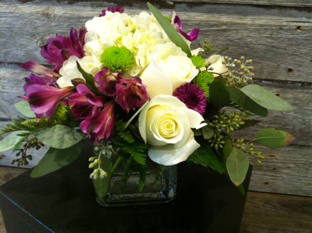 Roses, hydrangea, alstromeria and orchids in a cube 