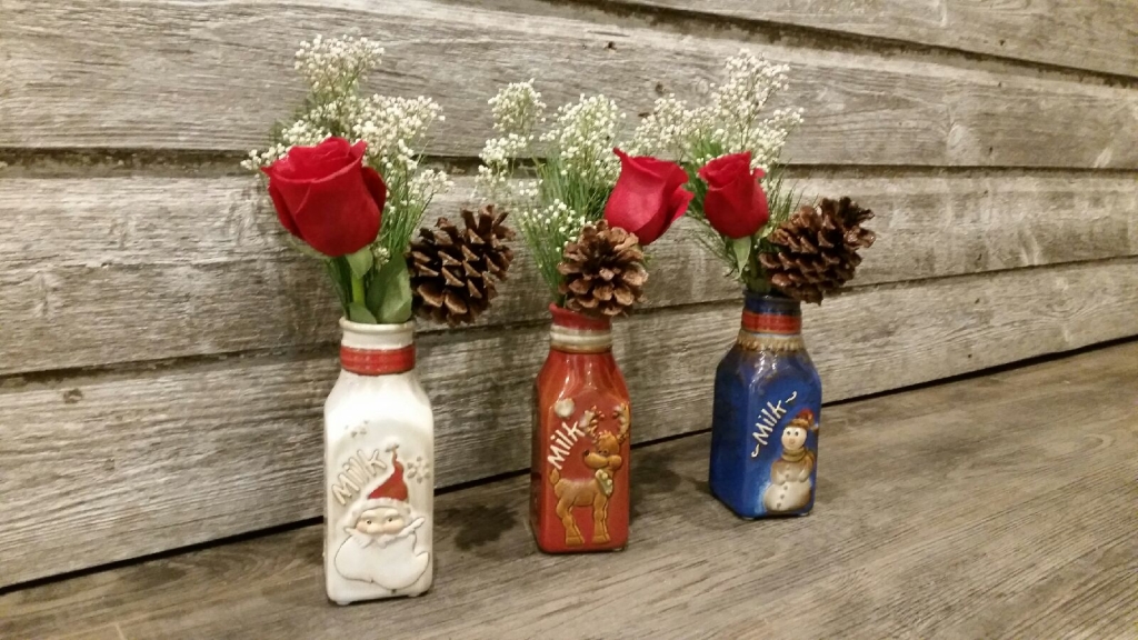Three roses in Santa milk jugs!