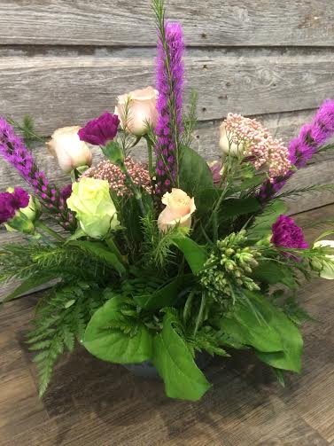 Sympathy arrangement with pinks, purples and greens 