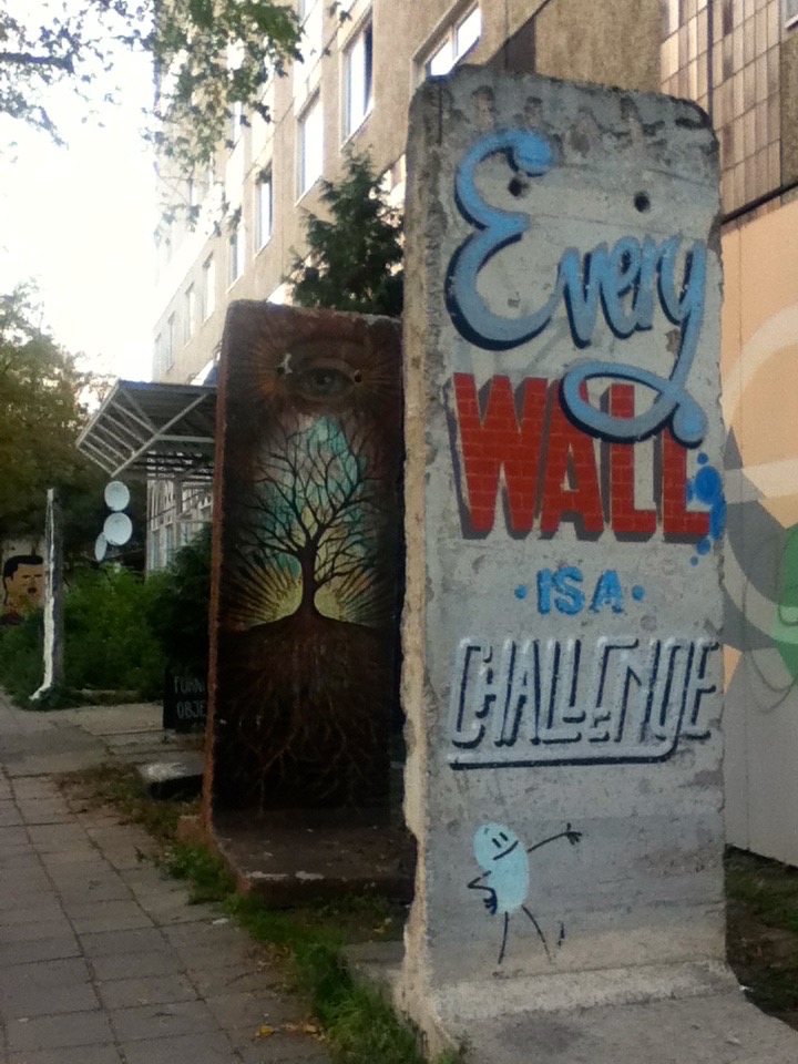 Sections of the Berlin Wall, preserved as canvases. 'Every Wall is a Challenge'.
