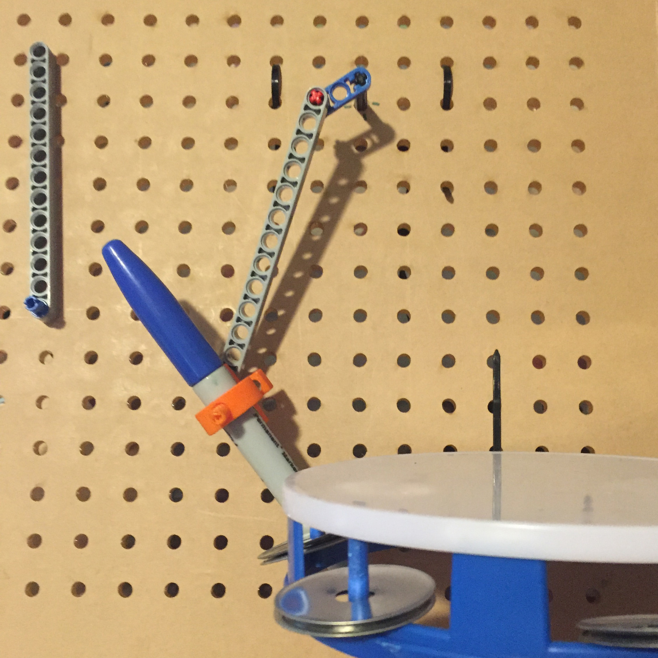 Lasercut prototype board for Musical Linkages, an activity developed by the Exploratorium in which you use motorized lego pieces that can be attached anywhere on a pegboard to create music making machines.