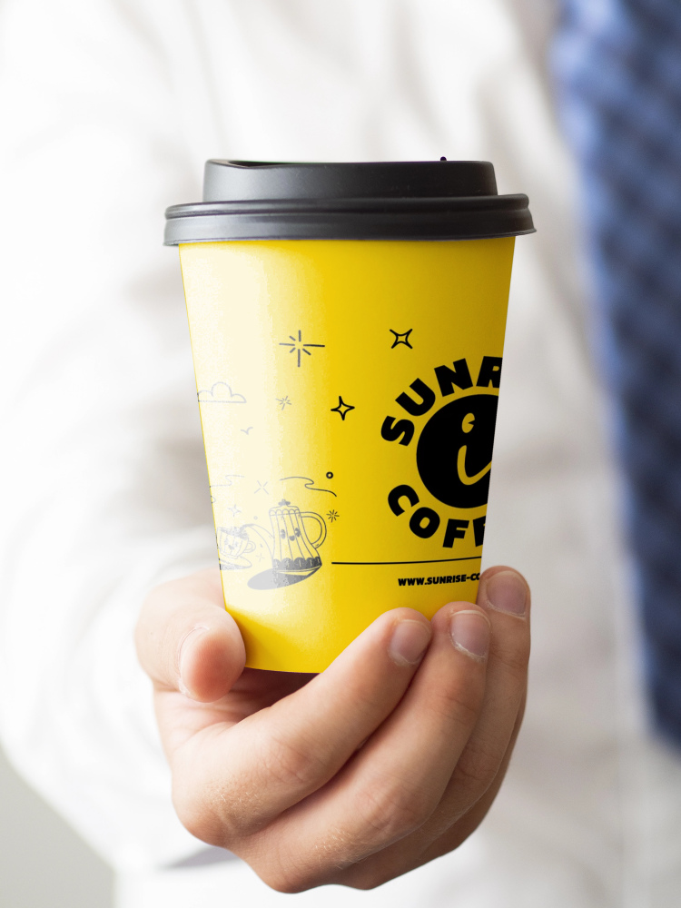 Man holding a cup of coffee close-up.png